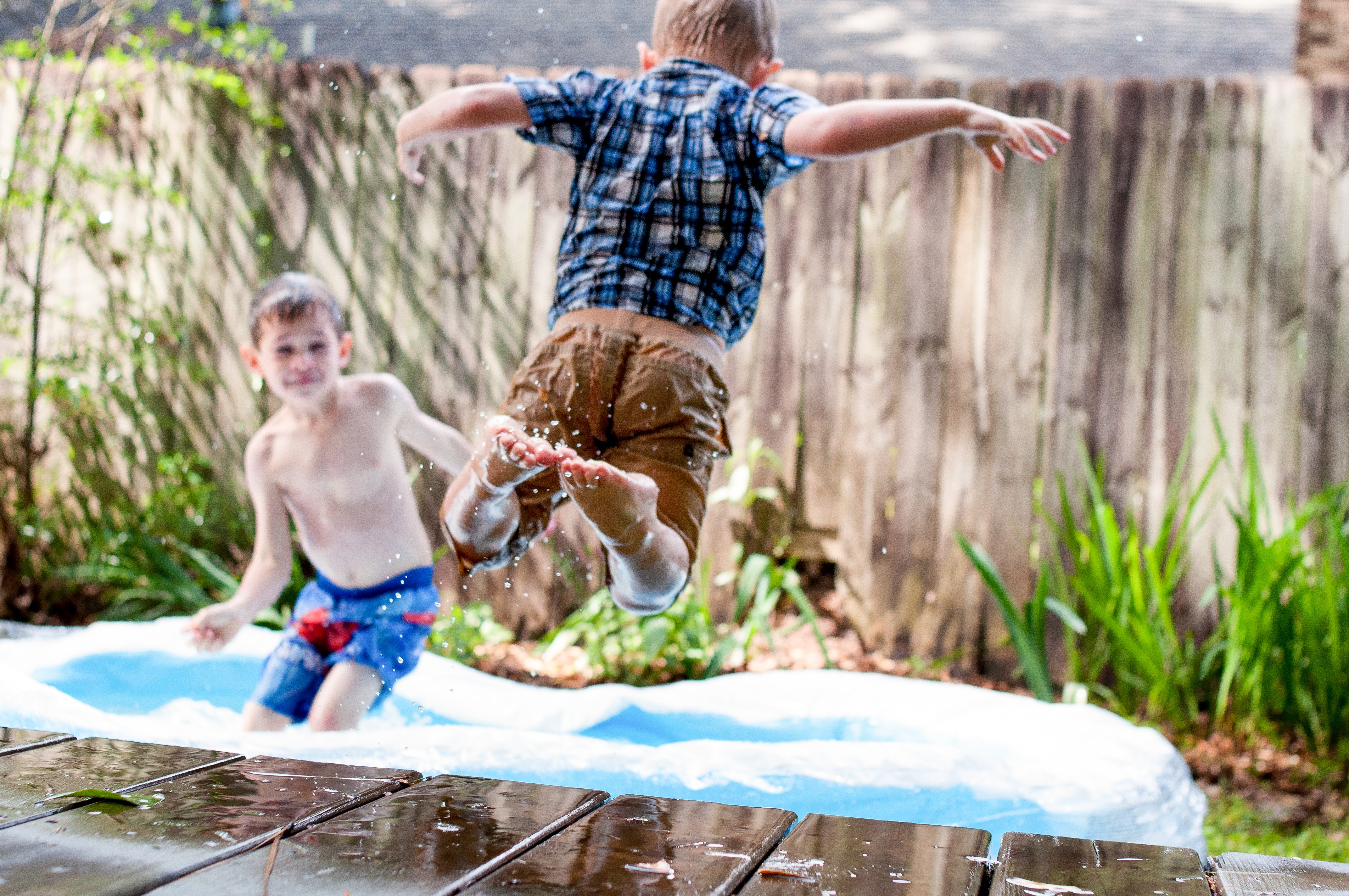 Children jumping into a pool